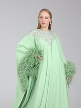 Load image into Gallery viewer, Close-up of embellishment on Dina Melwani green crystal-embellished feather-cuff kaftan
