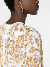 Load image into Gallery viewer, Close-up of embellishment on Dina Melwani white gold floral-embroidered kaftan dress
